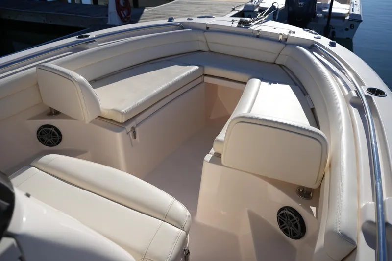 Slide: The Image of 2018 Grady-White Fisherman 236 boat interior with cushioned seating and speakers. - 39