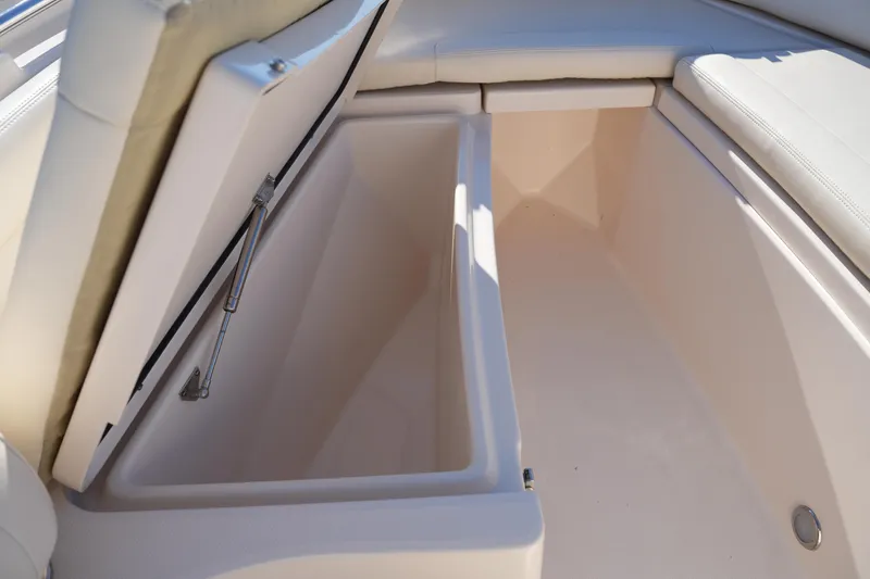 Slide: The Image of 2018 Grady-White Fisherman 236 boat storage compartment with open cushioned lid. - 41