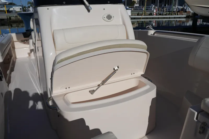 Slide: The Image of 2018 Grady-White Fisherman 236 boat seat with open storage compartment. - 43
