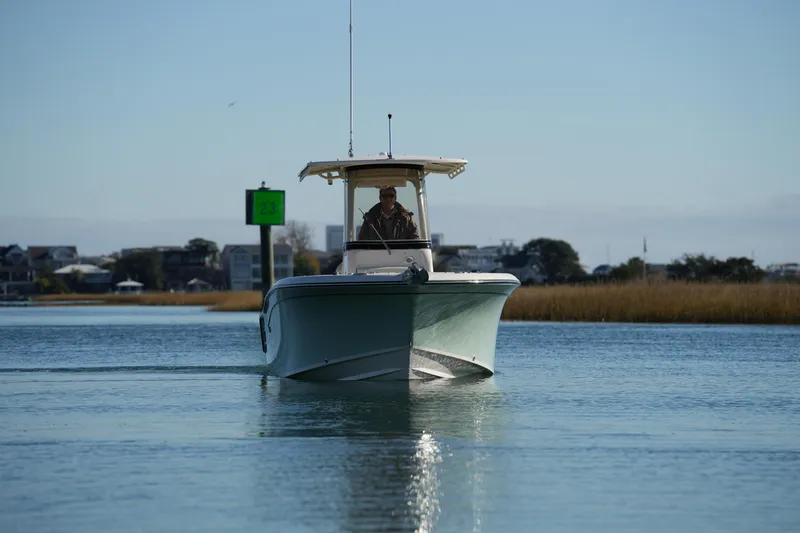 Slide: The Image of 2018 Grady-White Fisherman 236 boat navigating calm waters near shoreline. - 6