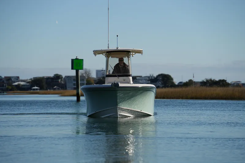 Slide: The Image of 2018 Grady-White Fisherman 236 boat navigating calm waters near shoreline. - 7