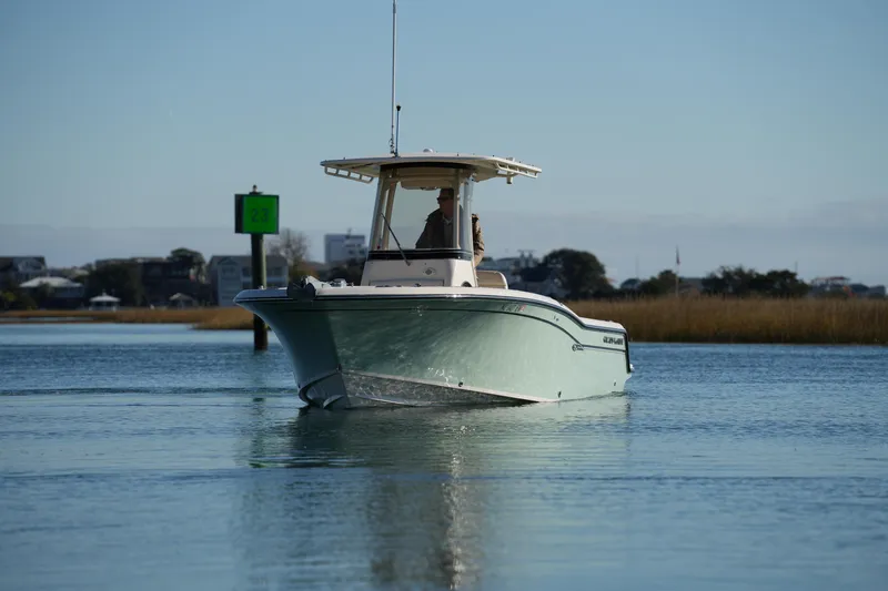 Slide: The Image of 2018 Grady-White Fisherman 236 boat cruising on calm water near shoreline. - 8