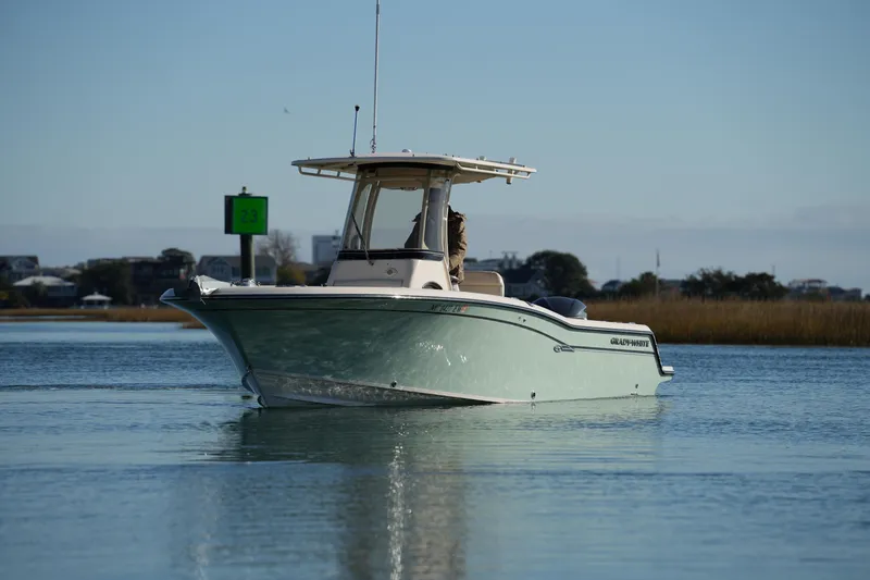Slide: The Image of 2018 Grady-White Fisherman 236 boat on calm water, near a green channel marker. - 9