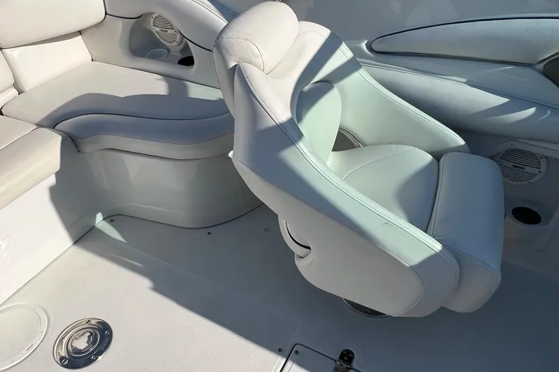 Slide: The Image of 2005 Crownline 226 LS boat interior with white seating and speaker detail. - 10