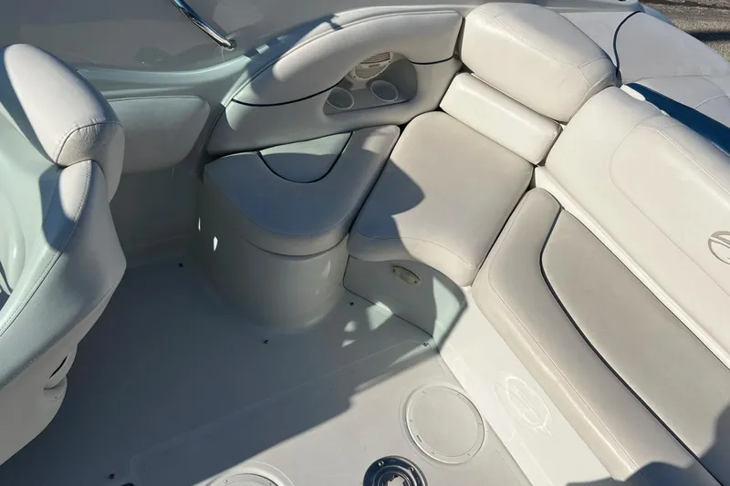 Slide: The Image of 2005 Crownline 226 LS boat interior with white cushioned seating and cup holders. - 12