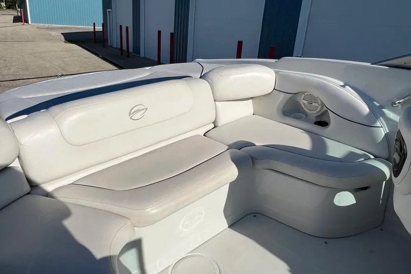 Slide: The Image of 2005 Crownline 226 LS boat interior with white cushioned seating and speaker. - 13