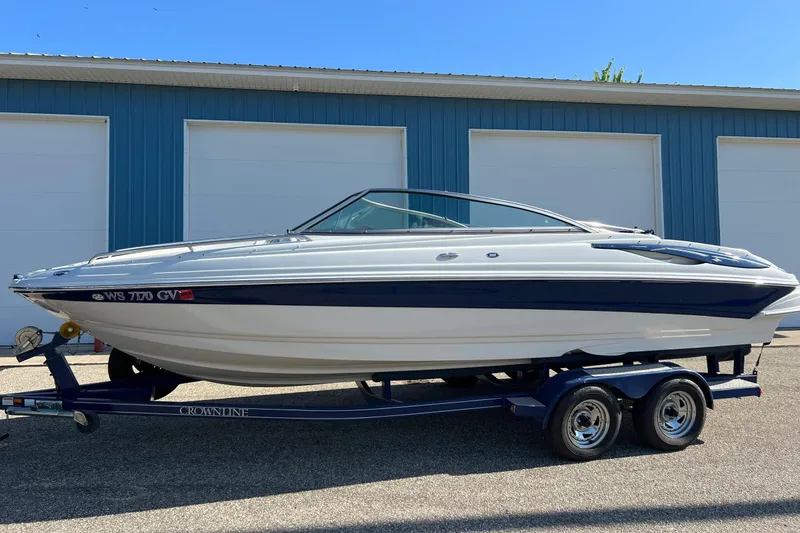 Slide: The Image of 2005 Crownline 226 LS boat on trailer, parked outside blue garage. - 14