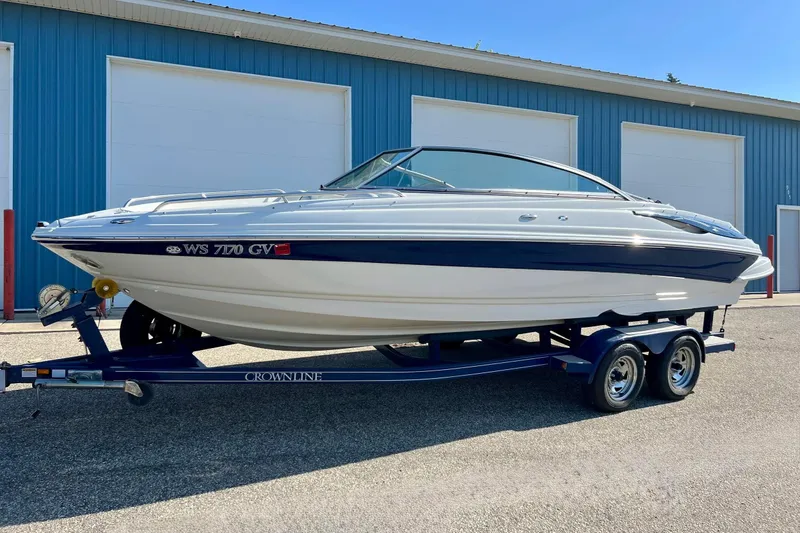 Slide: The Image of 2005 Crownline 226 LS boat on trailer, parked outside blue building. - 15