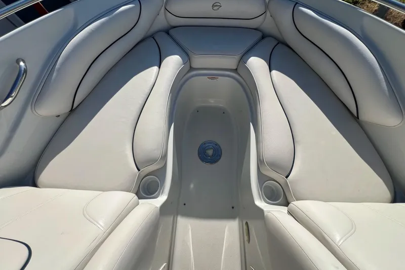 Slide: The Image of 2005 Crownline 226 LS boat interior with white cushioned seating and cup holders. - 4