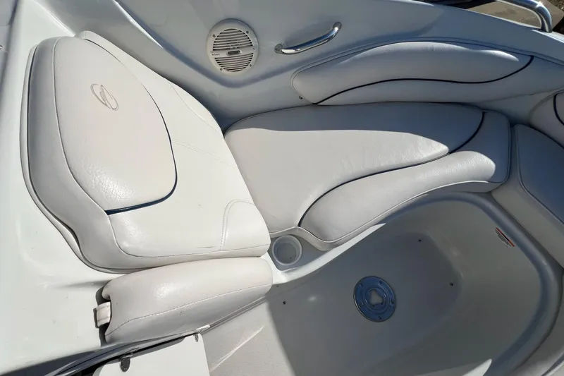 Slide: The Image of 2005 Crownline 226 LS boat interior with white cushioned seating and speaker. - 8