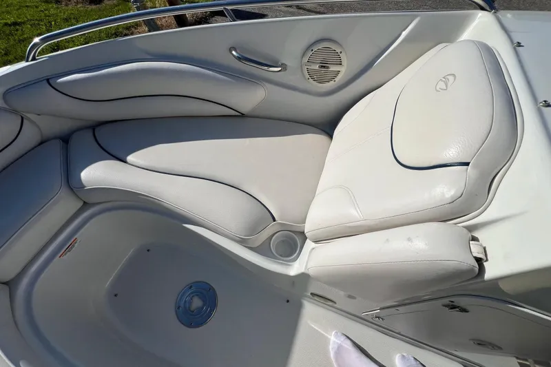 Slide: The Image of 2005 Crownline 226 LS boat interior with white cushioned seating and speaker. - 9