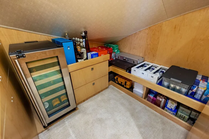 Slide: The Image of Storage area in 2018 Viking 80 Convertible yacht with fridge and organized supplies. - 18