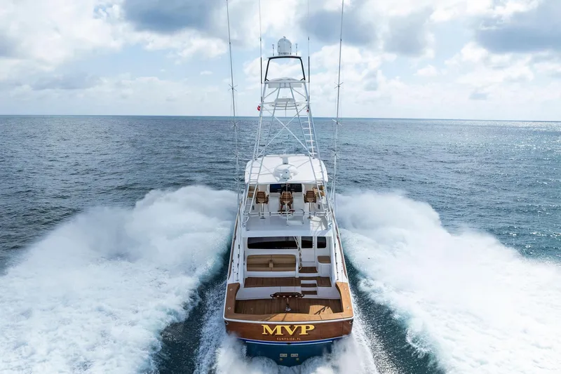 Slide: The Image of 2018 Viking 80 Convertible yacht cruising on open ocean under cloudy sky. - 4