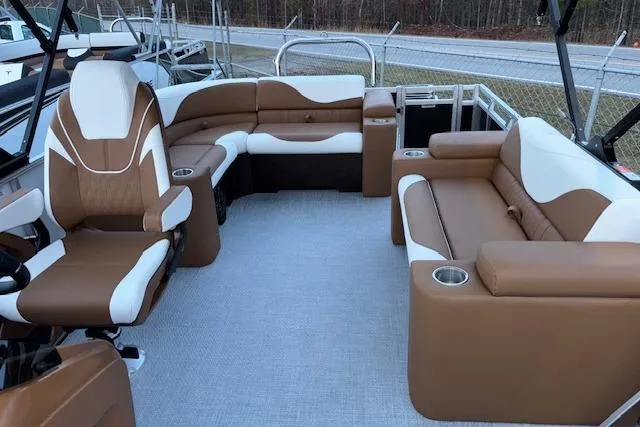 Slide: The Image of 2026 Tahoe Pontoon LTZ 2185 ELITE interior with brown and white seating, cup holders. - 12