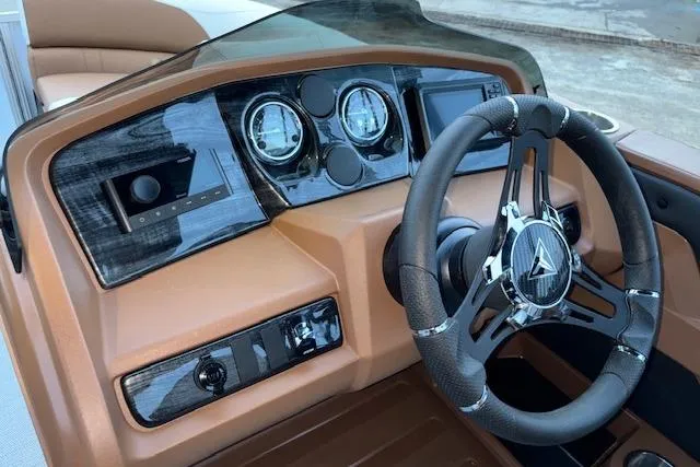 Slide: The Image of 2026 Tahoe Pontoon LTZ 2185 ELITE dashboard with modern steering and controls. - 16