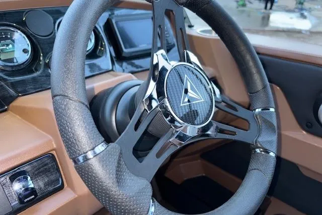 Slide: The Image of Steering wheel of 2026 Tahoe Pontoon LTZ 2185 ELITE, featuring modern dashboard design. - 19