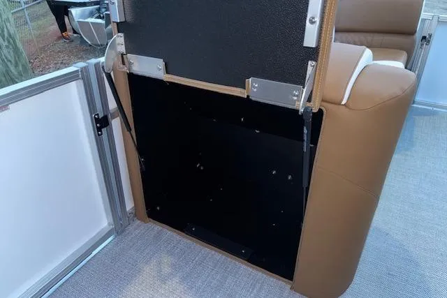 Slide: The Image of 2026 Tahoe Pontoon LTZ 2185 ELITE interior detail with brown seating and metal fixtures. - 26