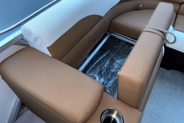 Slide: The Image of 2026 Tahoe Pontoon LTZ 2185 ELITE interior with brown and white seating, cup holder. - 29