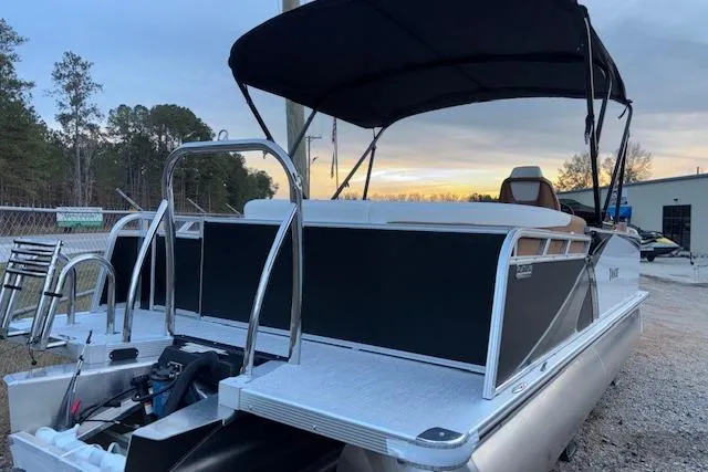 Slide: The Image of 2026 Tahoe Pontoon LTZ 2185 ELITE boat with canopy, docked at sunset. - 6