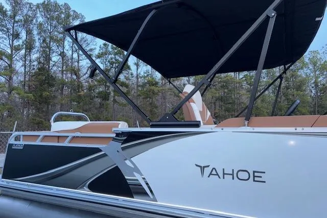 Slide: The Image of 2026 Tahoe Pontoon LTZ 2185 ELITE with canopy, parked outdoors near trees. - 8