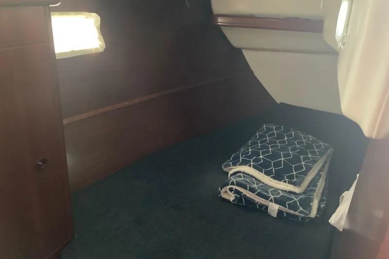 Slide: The Image of Cozy cabin interior of 2000 Beneteau Oceanis 361 sailboat with folded blanket. - 22
