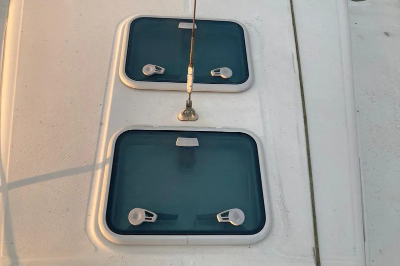 Slide: The Image of Deck hatches on a 2000 Beneteau Oceanis 361 sailboat, featuring blue-tinted windows. - 7