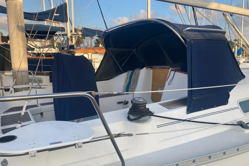 Slide: The Image of Beneteau Oceanis 361 sailboat, 2000 model, docked with blue canopy and winch. - 8