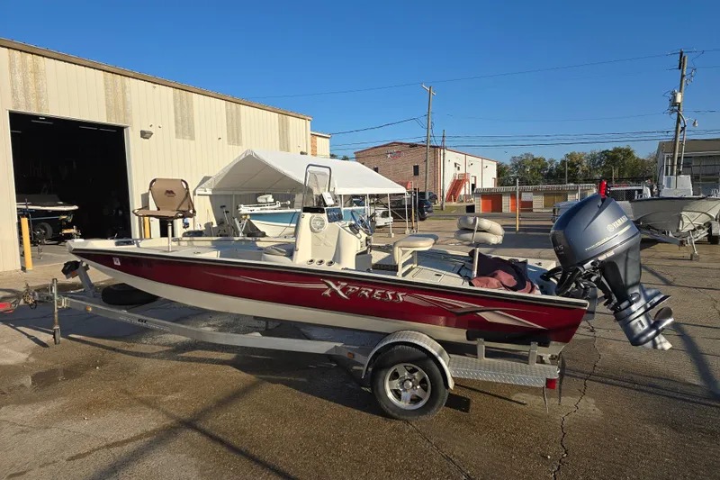 Slide: The Image of 2013 Xpress H20B Bay boat on trailer with Yamaha outboard motor. - 2
