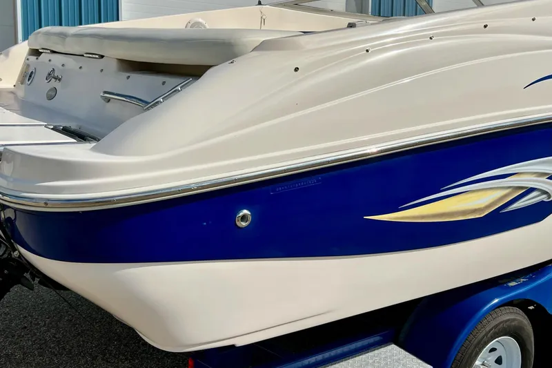 Slide: The Image of 2004 Rinker 232 Captiva Bowrider boat engine detail in a garage setting. - 10