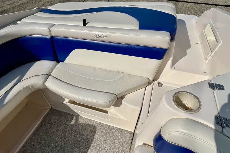 Slide: The Image of 2004 Rinker 232 Captiva Bowrider interior with blue and white seating. - 15