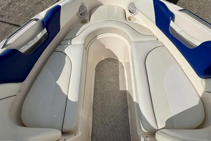 Slide: The Image of 2004 Rinker 232 Captiva Bowrider interior seating with blue and white upholstery. - 22