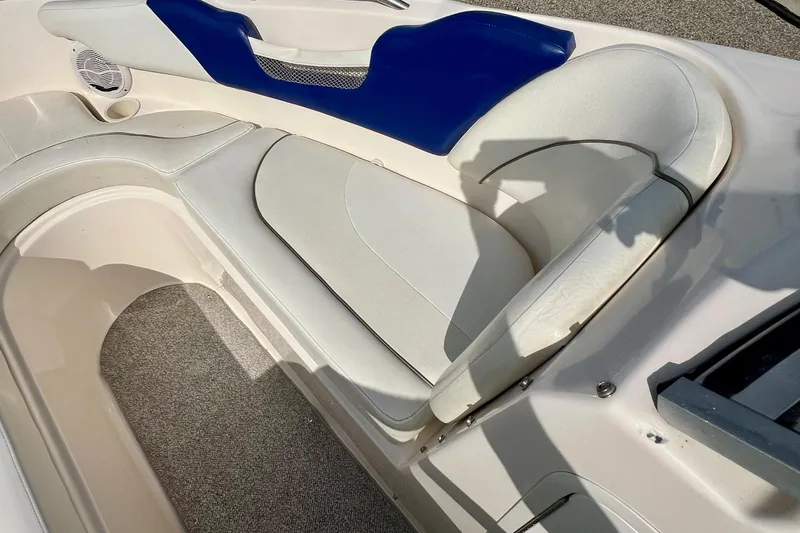 Slide: The Image of 2004 Rinker 232 Captiva Bowrider interior with white and blue seating. - 23