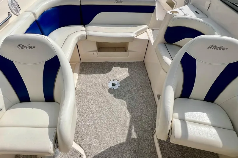 Slide: The Image of 2004 Rinker 232 Captiva Bowrider interior with white and blue seating. - 24