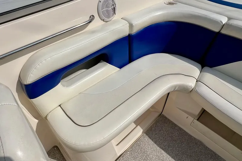 Slide: The Image of 2004 Rinker 232 Captiva Bowrider cockpit with steering wheel and captain's chair. - 26