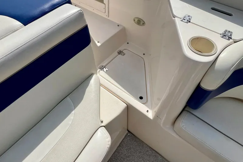 Slide: The Image of 2004 Rinker 232 Captiva Bowrider interior seating with blue and white upholstery. - 27