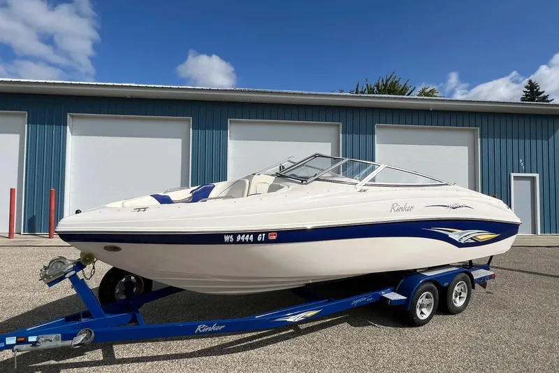 Slide: The Image of 2004 Rinker 232 Captiva Bowrider on trailer, parked outside blue garage. - 30