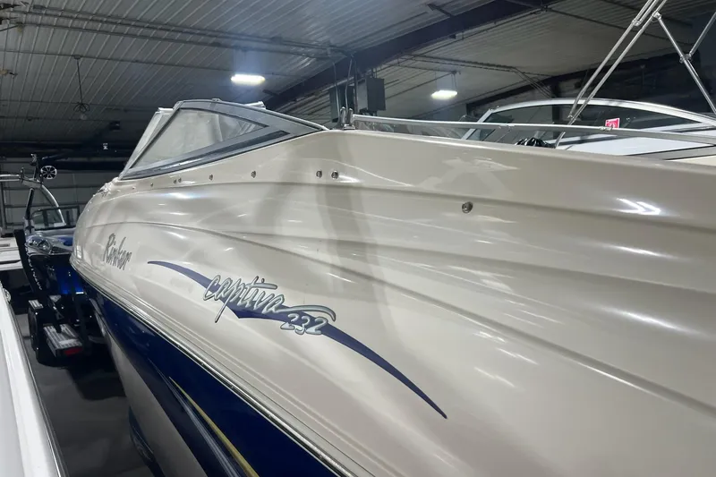 Slide: The Image of 2004 Rinker 232 Captiva Bowrider boat in indoor storage facility. - 32