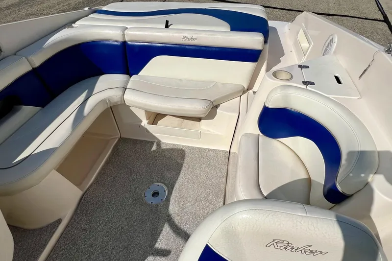 Slide: The Image of 2004 Rinker 232 Captiva Bowrider interior with blue and white seating. - 4
