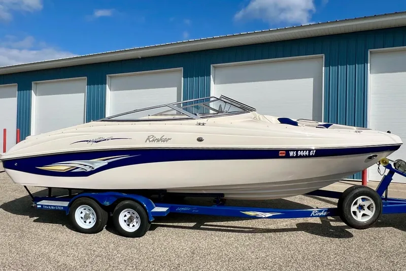 Slide: The Image of 2004 Rinker 232 Captiva Bowrider interior with blue and white seating. - 5