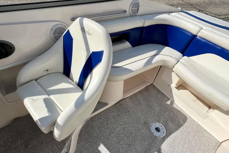 Slide: The Image of 2004 Rinker 232 Captiva Bowrider interior with blue and white seating. - 6