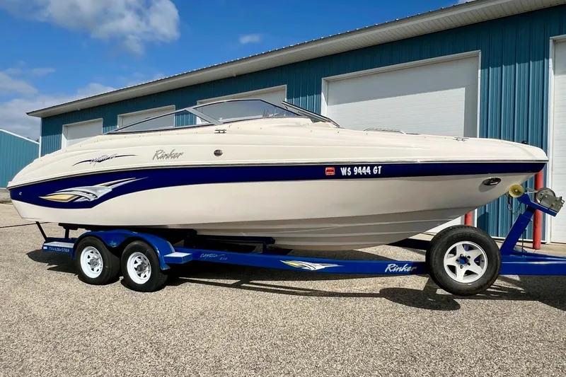 Slide: The Image of 2004 Rinker 232 Captiva Bowrider dashboard with wood accents and steering wheel. - 7