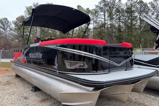 The Image of 2026 Tahoe Pontoon LTZ 2385 VRB Tritoon with red seating and black canopy. - 1