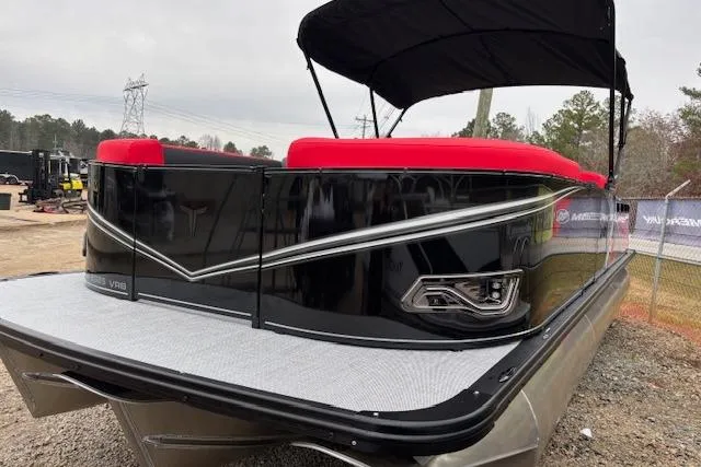 Slide: The Image of 2026 Tahoe Pontoon LTZ 2385 VRB Tritoon with red seating and sleek black exterior. - 10