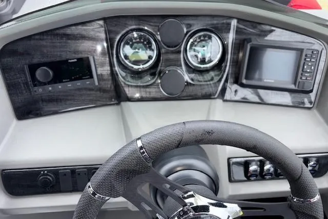 Slide: The Image of Dashboard of 2026 Tahoe Pontoon LTZ 2385 VRB Tritoon with steering wheel and gauges. - 21