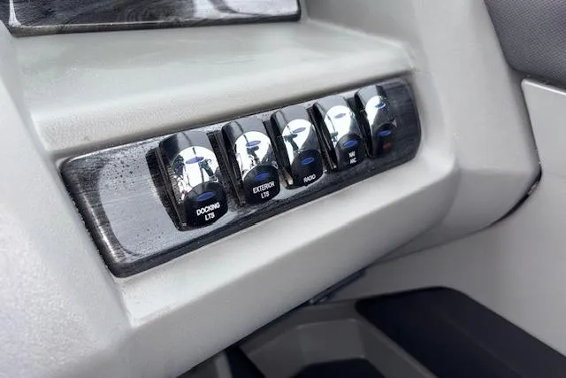Slide: The Image of Control panel of 2026 Tahoe Pontoon LTZ 2385 VRB Tritoon with labeled switches. - 24