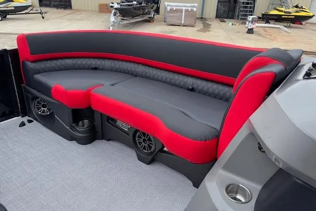 Slide: The Image of 2026 Tahoe Pontoon LTZ 2385 VRB Tritoon with red and black seating, cup holders, and speakers. - 26