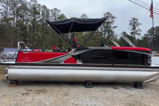Slide: The Image of 2026 Tahoe Pontoon LTZ 2385 VRB Tritoon with red and black design, parked outdoors. - 4