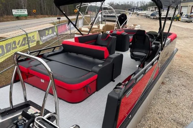 Slide: The Image of 2026 Tahoe Pontoon LTZ 2385 VRB Tritoon with red and black seating, docked outdoors. - 7