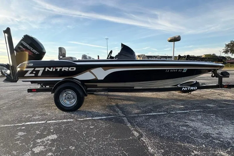 Slide: The Image of 2013 Nitro Z-7 boat with Mercury Pro XS engine on trailer, parked outdoors. - 1