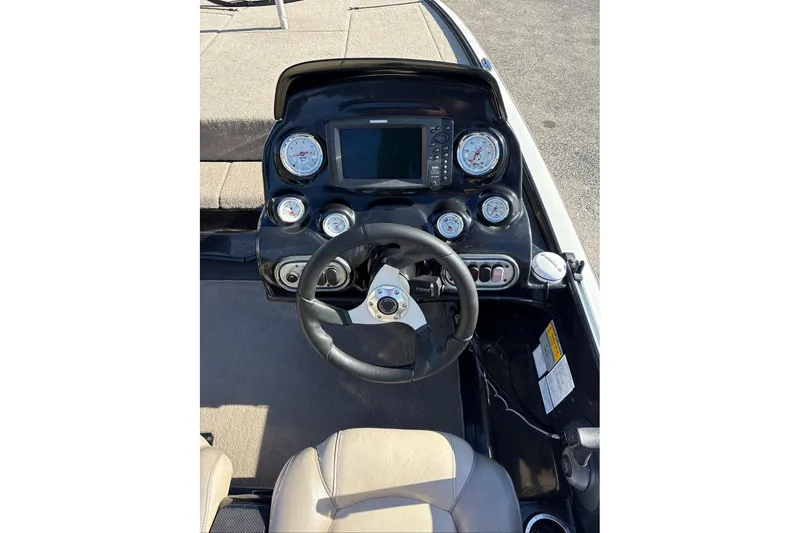 Slide: The Image of 2013 Nitro Z-7 boat dashboard with steering wheel and gauges. - 15